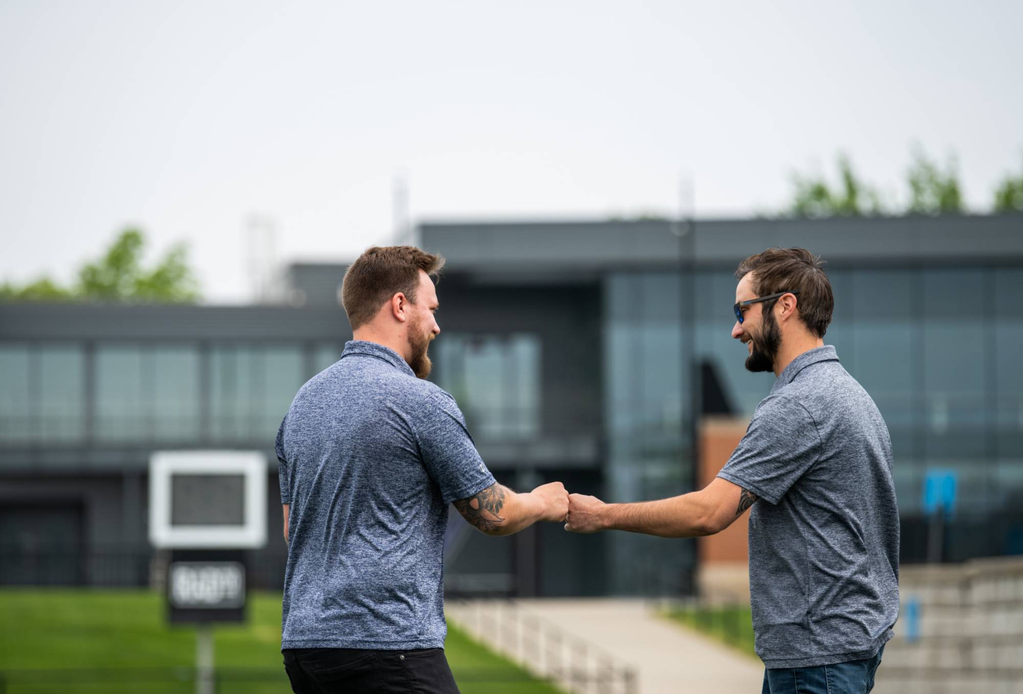 Jake Mallekoote and Matt DeRuiter fist bumping at the 2022 Cornhole Tournament